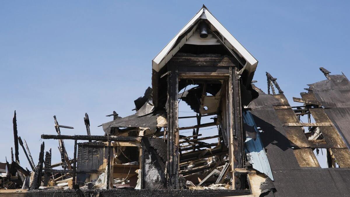 The charred remains of a fire damaged home. On Side Restoration