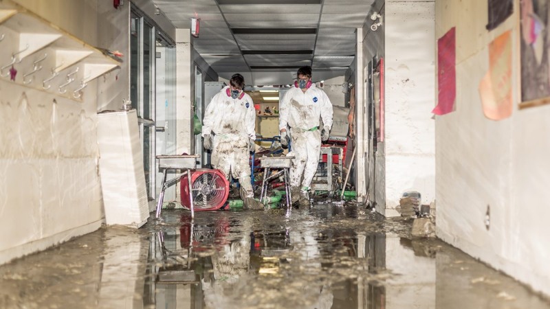 Two onside workers cleaning flood damage