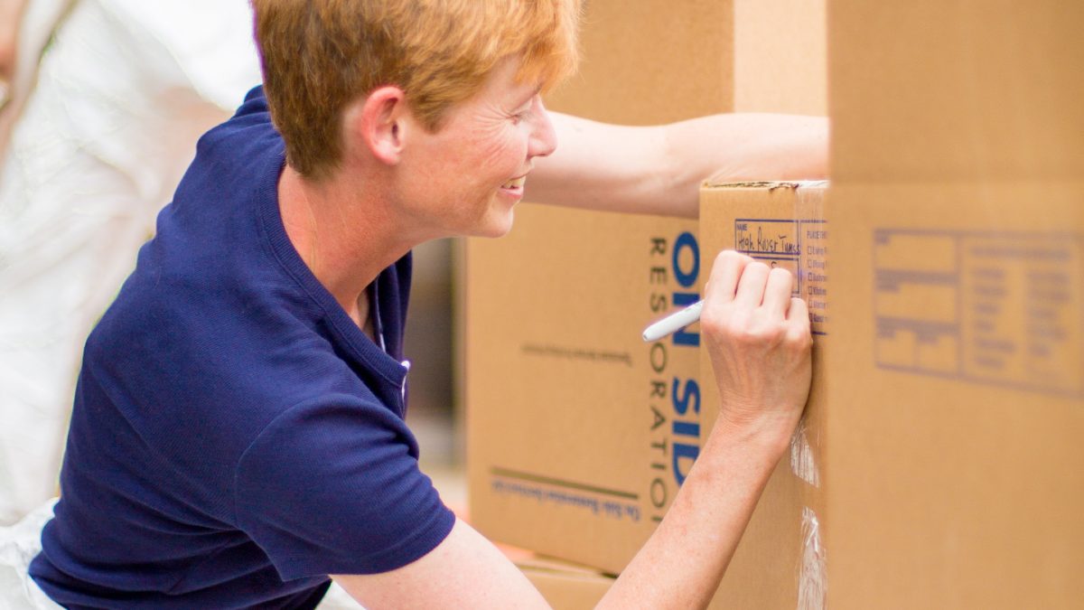 A staff member packs contents to be recovered and restored.