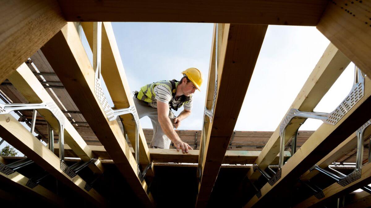 A workman repairing a damaged roof.